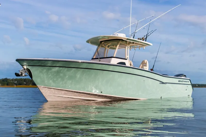 Next Level Yacht Photos Pics 2019 Grady-White Canyon 306 boat on calm water under blue sky.