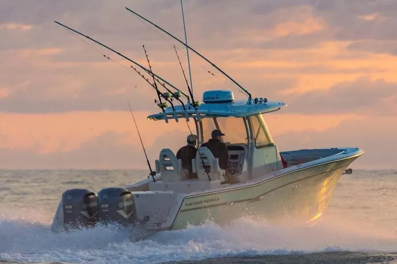Next Level Yacht Photos Pics 2019 Grady-White Canyon 306 boat cruising at sunset with fishing rods.