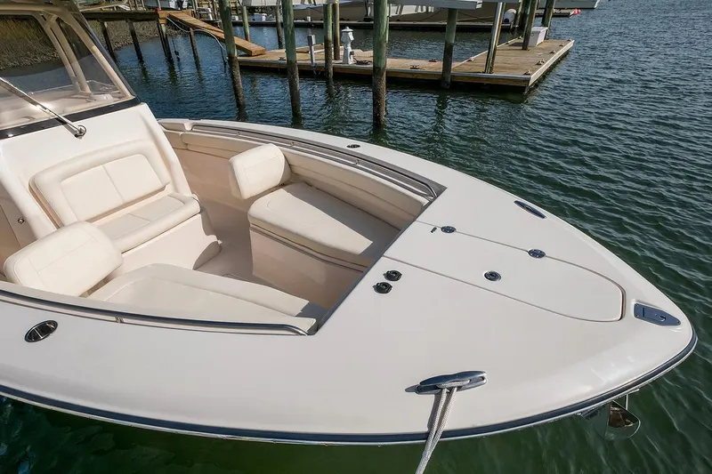 Next Level Yacht Photos Pics 2019 Grady-White Canyon 306 boat with spacious seating, docked on calm water.