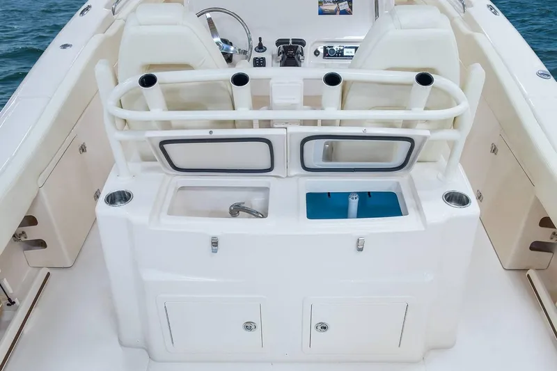 Next Level Yacht Photos Pics 2019 Grady-White Canyon 306 boat interior with helm, rod holders, and storage compartments.
