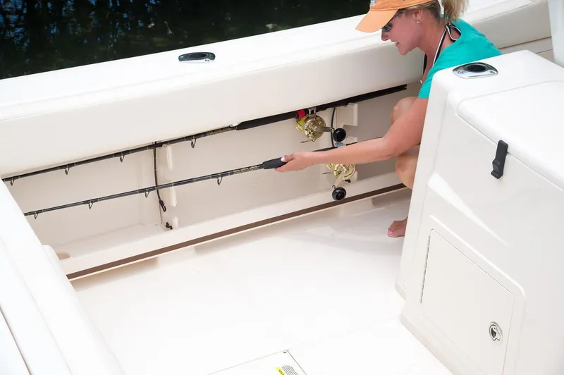 Next Level Yacht Photos Pics Woman storing fishing rod on 2019 Grady-White Canyon 306 boat.