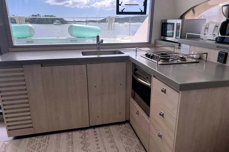  Yacht Photos Pics Modern kitchen interior on 2020 Leopard 43 Powercat yacht with appliances and scenic window view.