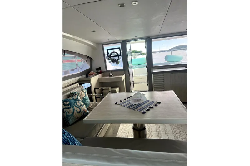  Yacht Photos Pics Interior of 2020 Leopard 43 Powercat yacht with dining area and scenic window view.