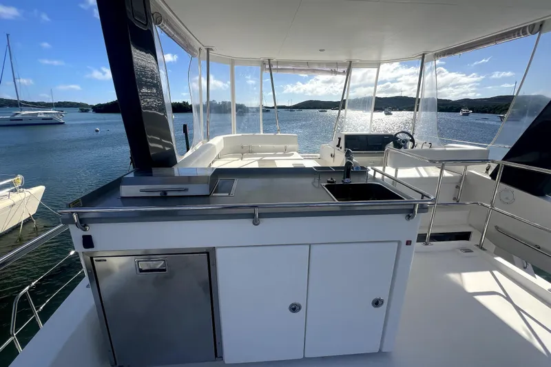  Yacht Photos Pics 2020 Leopard 43 Powercat yacht with outdoor kitchen, sink, and scenic water view.