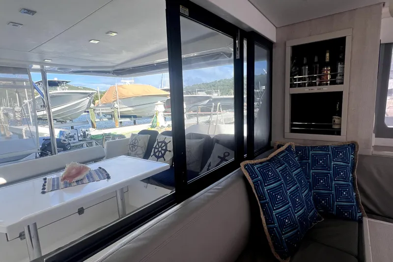  Yacht Photos Pics Interior of 2020 Leopard 43 Powercat with seating, table, and marina view.