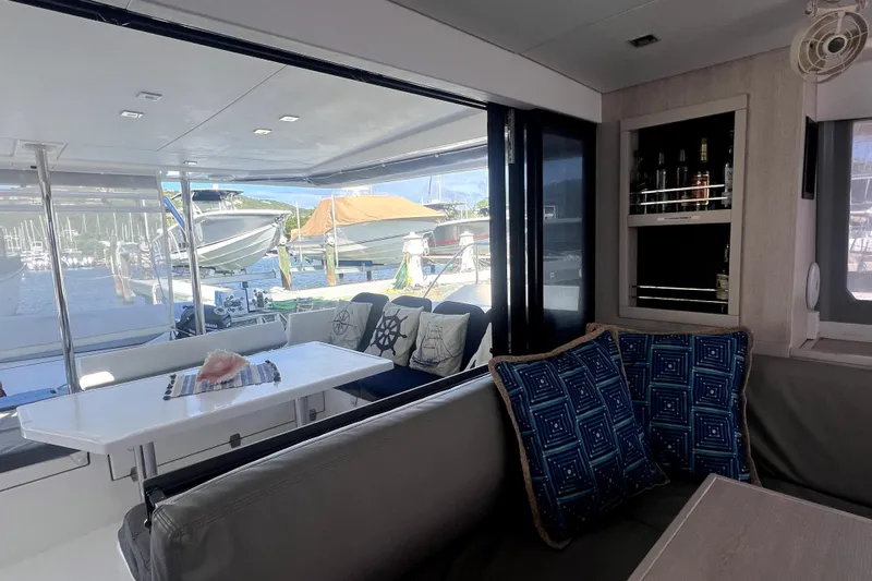  Yacht Photos Pics Interior view of 2020 Leopard 43 Powercat yacht with seating and marina backdrop.