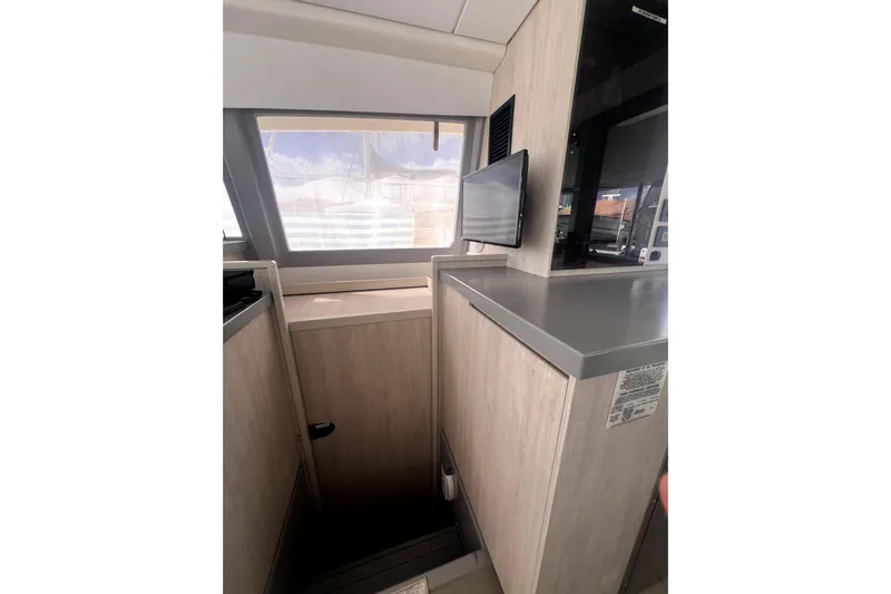  Yacht Photos Pics Interior of 2020 Leopard 43 Powercat with modern wood finish and compact TV.