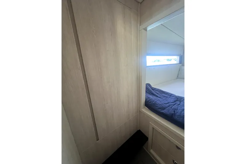  Yacht Photos Pics Interior cabin of 2020 Leopard 43 Powercat with wooden paneling and bed.