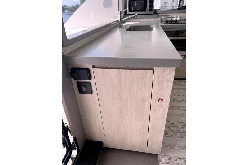  Yacht Photos Pics Modern kitchen area in a 2020 Leopard 43 Powercat yacht, featuring sleek countertops and appliances.