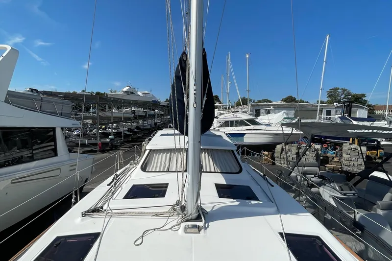  Yacht Photos Pics 2013 Gemini Legacy sailboat docked among other boats under clear blue sky.