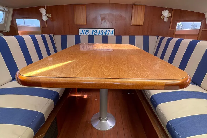  Yacht Photos Pics Cozy boat interior with striped seating and wooden table, Gemini Legacy 2013 model.
