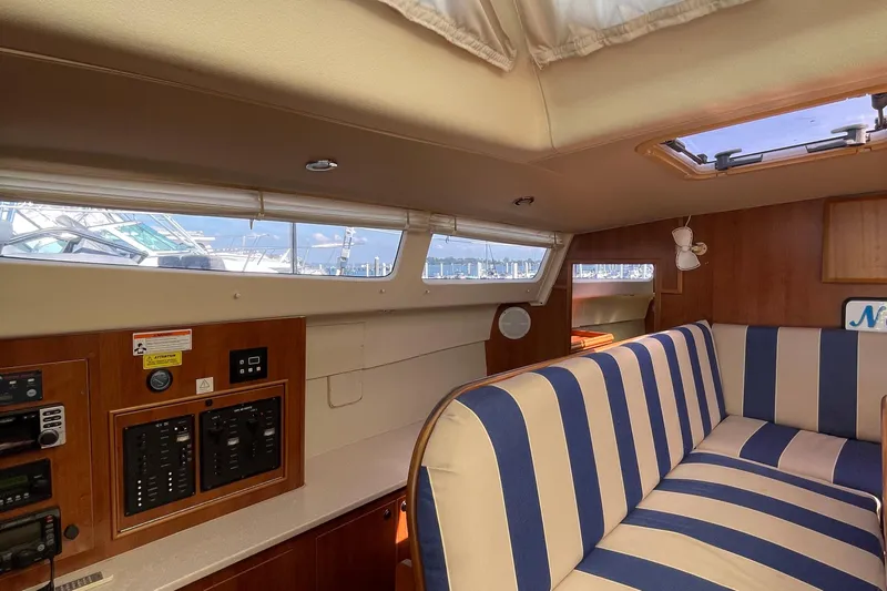  Yacht Photos Pics Interior of 2013 Gemini Legacy boat with striped seating and control panels.