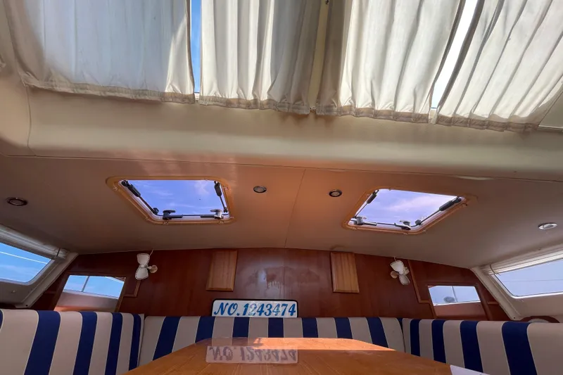  Yacht Photos Pics Interior of 2013 Gemini Legacy boat with striped seating and skylights.