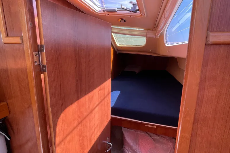  Yacht Photos Pics Interior cabin of 2013 Gemini Legacy boat with wooden door and cozy sleeping area.