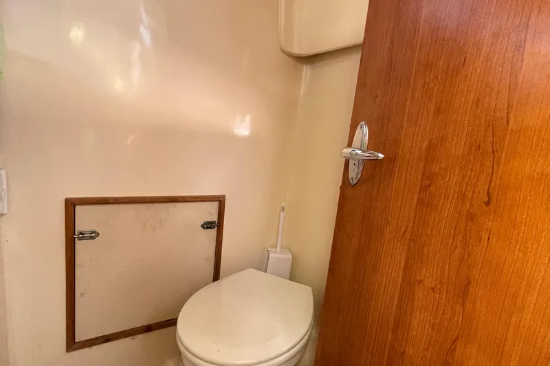  Yacht Photos Pics Compact bathroom in 2013 Gemini Legacy boat with wooden door and toilet.