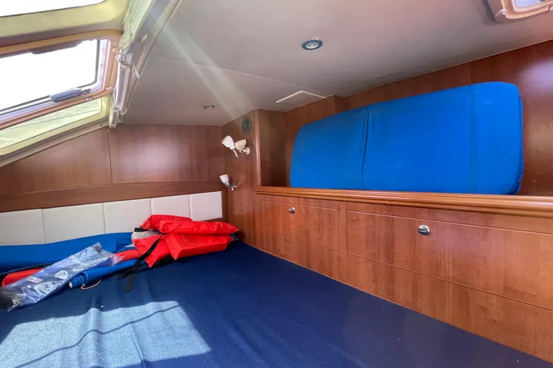  Yacht Photos Pics Interior cabin of 2013 Gemini Legacy boat with wooden finish and life jackets.