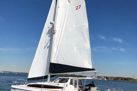  Yacht Photos Pics Sailing catamaran Gemini Legacy 2013 on open water under clear blue sky.
