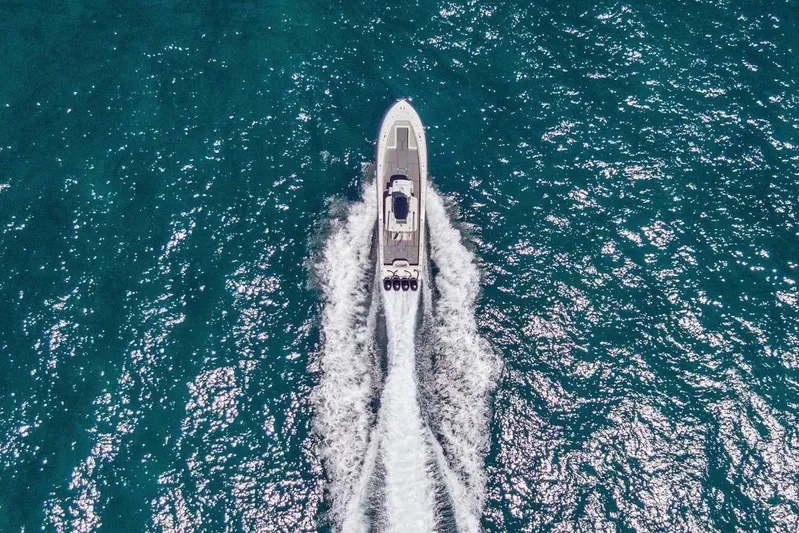  Yacht Photos Pics Aerial view of 2013 Invincible 42 Open Fisherman boat cruising on blue ocean waters.