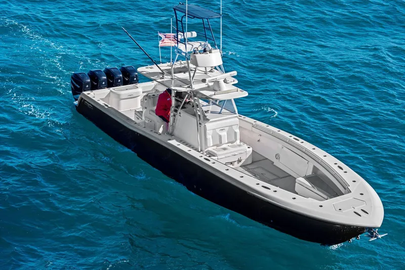  Yacht Photos Pics 2013 Invincible 42 Open Fisherman boat cruising on blue ocean waters.