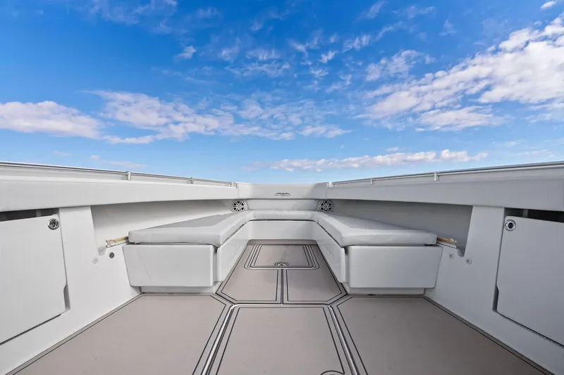  Yacht Photos Pics 2013 Invincible 42 Open Fisherman boat interior with cushioned seating under a clear blue sky.