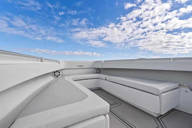  Yacht Photos Pics 2013 Invincible 42 Open Fisherman boat interior with cushioned seating under a blue sky.