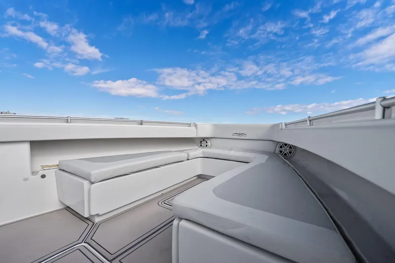  Yacht Photos Pics 2013 Invincible 42 Open Fisherman boat interior with cushioned seating under a blue sky.