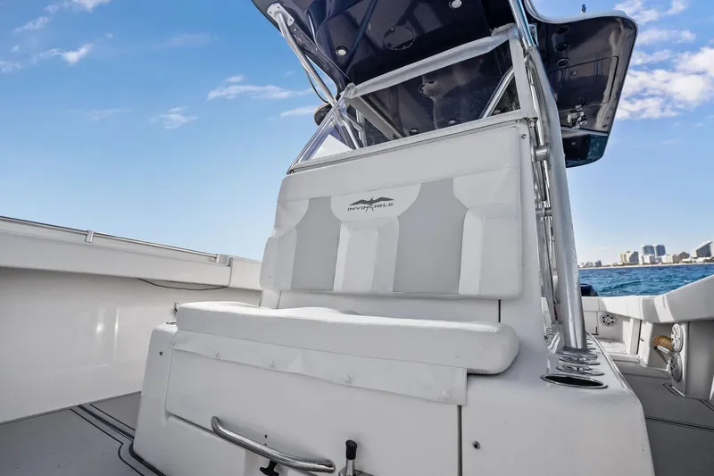  Yacht Photos Pics 2013 Invincible 42 Open Fisherman boat interior with seating, ocean view, and city skyline.