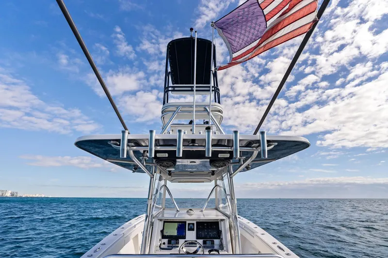  Yacht Photos Pics 2013 Invincible 42 Open Fisherman boat with American flag, ocean view, and clear sky.