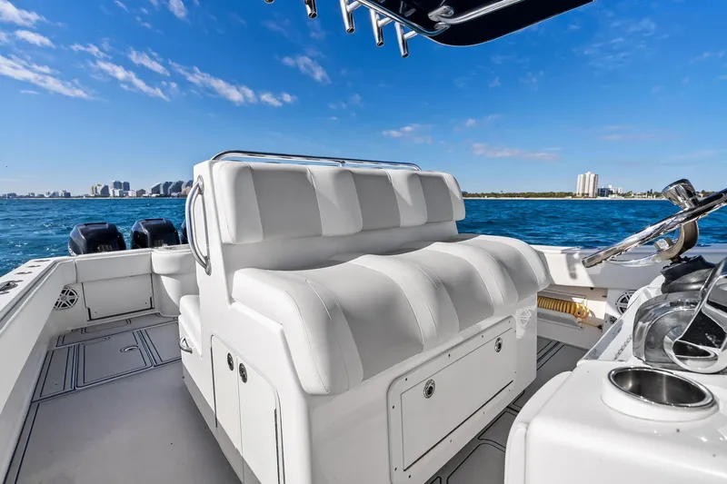 Yacht Photos Pics 2013 Invincible 42 Open Fisherman boat interior with white seating, ocean view, and city skyline.