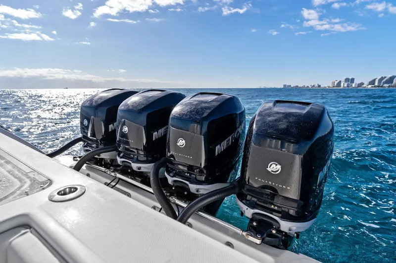  Yacht Photos Pics Four Mercury outboard engines on a 2013 Invincible 42 Open Fisherman boat in open water.