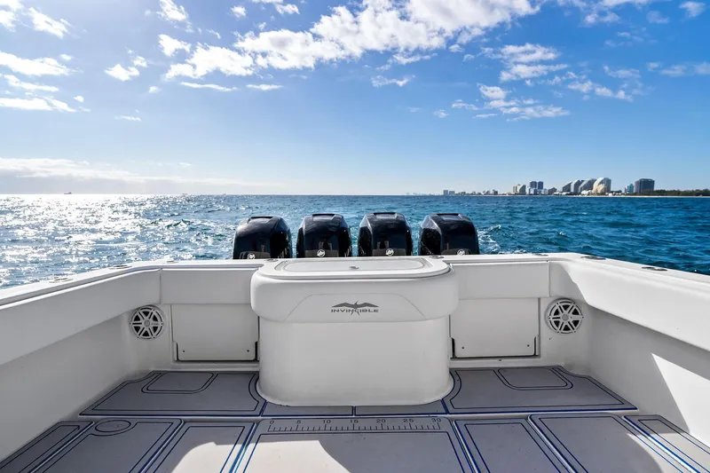  Yacht Photos Pics 2013 Invincible 42 Open Fisherman boat on ocean, city skyline in background.