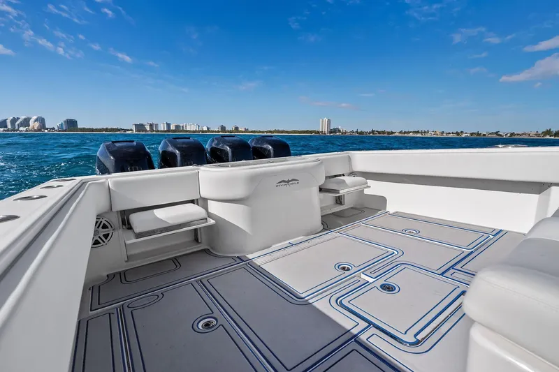  Yacht Photos Pics 2013 Invincible 42 Open Fisherman boat on water, city skyline in background.