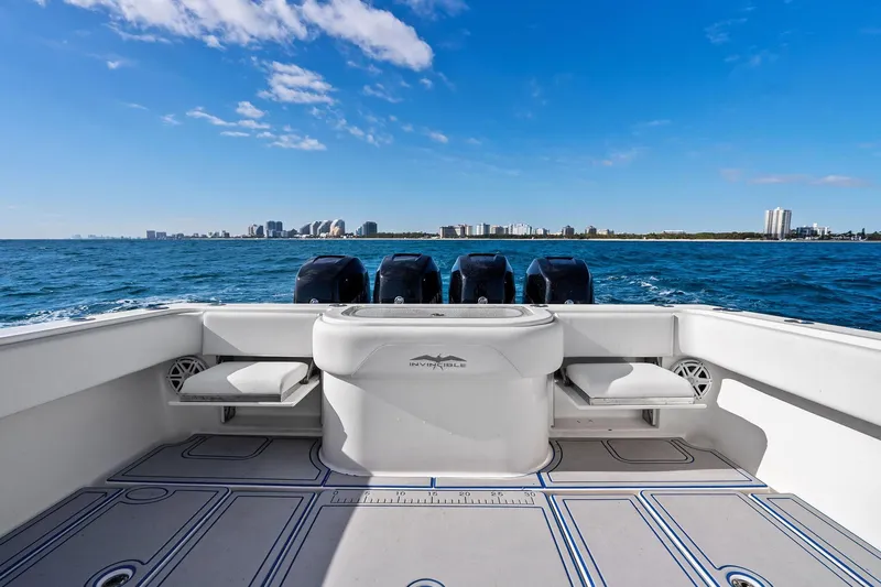  Yacht Photos Pics 2013 Invincible 42 Open Fisherman boat on ocean with city skyline in background.
