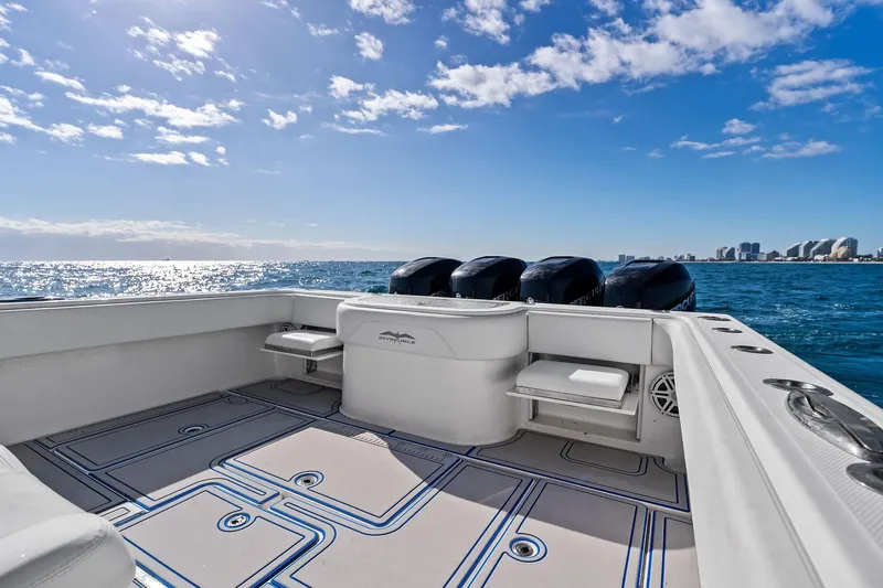  Yacht Photos Pics 2013 Invincible 42 Open Fisherman boat on ocean, clear sky, city skyline in background.