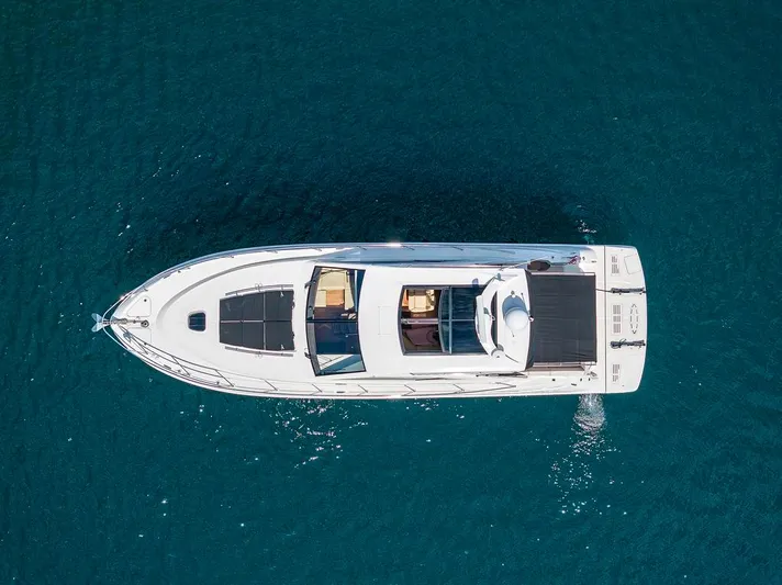  Yacht Photos Pics Aerial view of 2015 Sea Ray 510 Sundancer yacht on blue water.