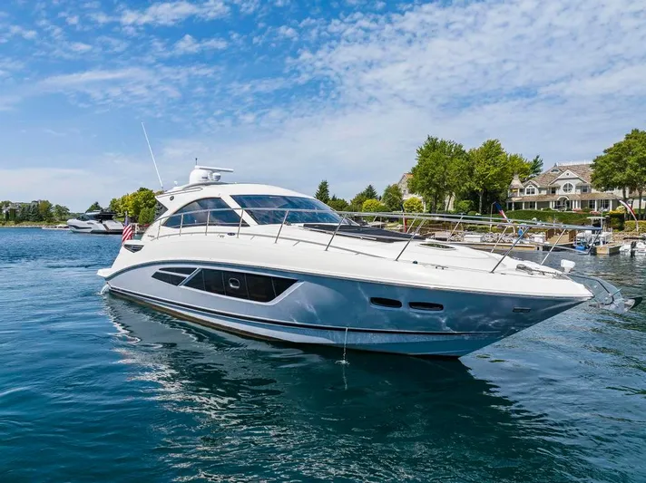  Yacht Photos Pics 2015 Sea Ray 510 Sundancer yacht on calm water, clear sky, and scenic shoreline.