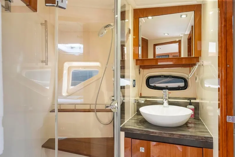  Yacht Photos Pics Luxurious bathroom in 2015 Sea Ray 510 Sundancer yacht with modern fixtures and wood accents.
