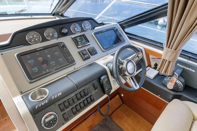  Yacht Photos Pics 2015 Sea Ray 510 Sundancer helm with advanced navigation controls and luxurious interior.