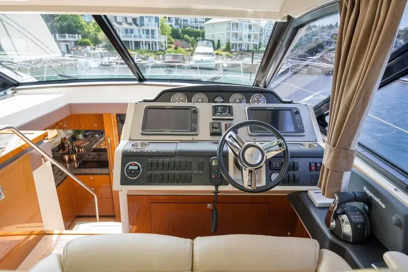  Yacht Photos Pics 2015 Sea Ray 510 Sundancer helm with modern controls and luxurious interior.