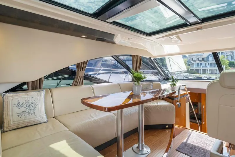  Yacht Photos Pics Luxurious interior of 2015 Sea Ray 510 Sundancer yacht with elegant seating and skylight.