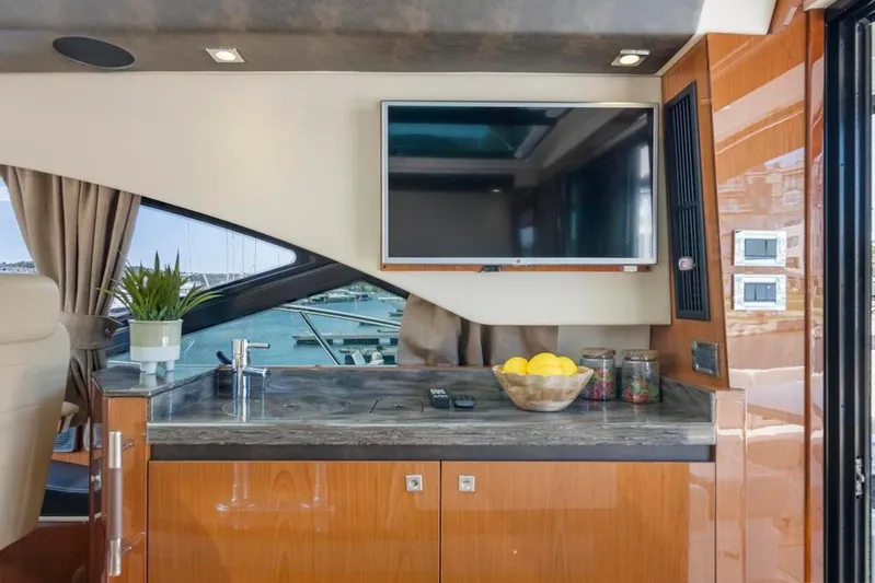  Yacht Photos Pics Luxurious interior of 2015 Sea Ray 510 Sundancer yacht with TV and kitchenette.