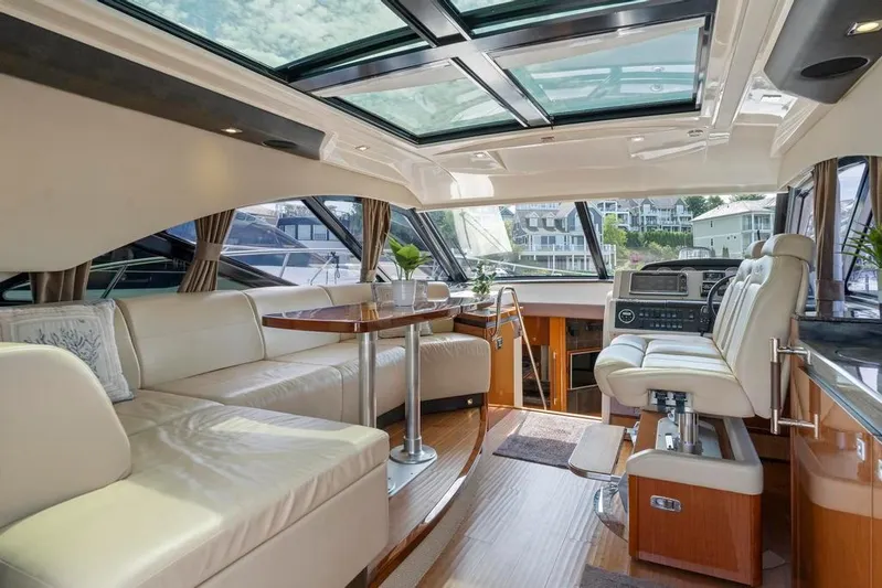  Yacht Photos Pics Luxurious interior of 2015 Sea Ray 510 Sundancer yacht with leather seating and panoramic windows.