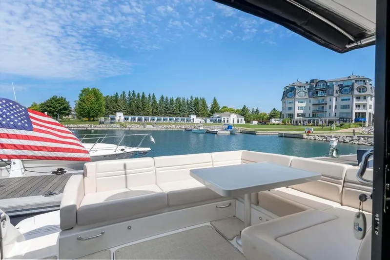  Yacht Photos Pics 2015 Sea Ray 510 Sundancer yacht with seating area, docked in a scenic marina.