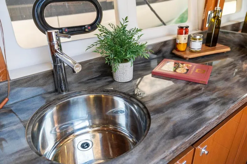  Yacht Photos Pics Luxurious kitchen sink area in 2015 Sea Ray 510 Sundancer yacht with modern fixtures.