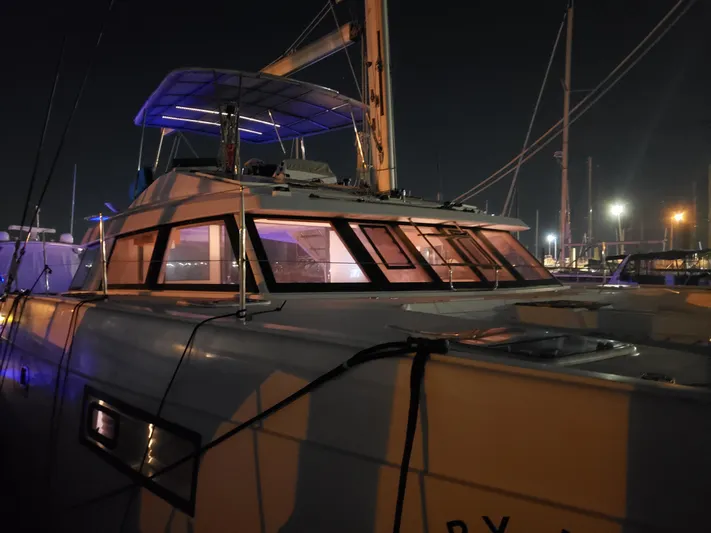 Nauti By Nature Yacht Photos Pics Nautitech 46 Fly 2017 catamaran docked at night with illuminated windows.