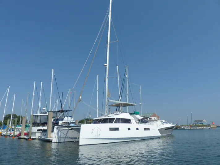 Nauti By Nature Yacht Photos Pics Nautitech 46 Fly 2017 catamaran docked in a marina under clear blue skies.