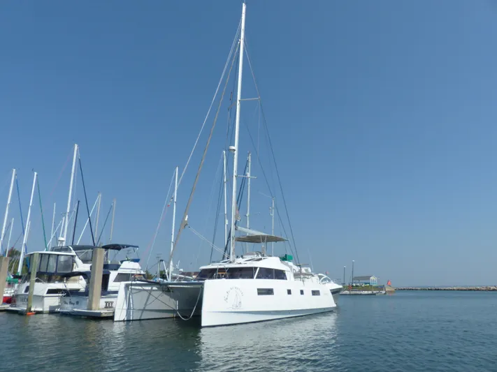 Nauti By Nature Yacht Photos Pics 2017 Nautitech 46 Fly catamaran docked in a marina under clear blue sky.