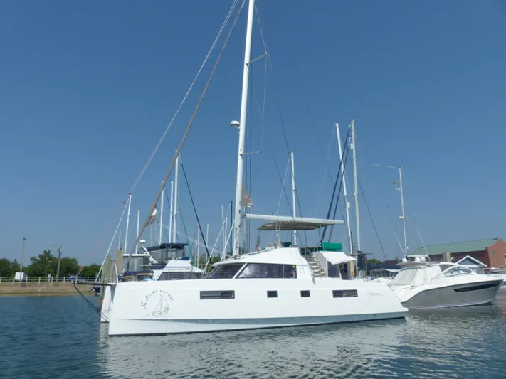 Nauti By Nature Yacht Photos Pics 2017 Nautitech 46 Fly catamaran docked in a marina under clear blue sky.