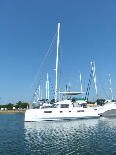 Nauti By Nature Yacht Photos Pics 2017 Nautitech 46 Fly catamaran docked in a marina under clear blue sky.
