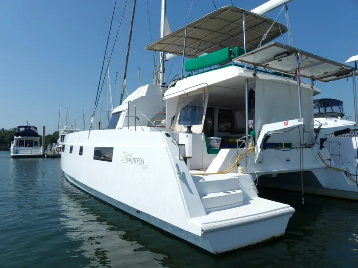 Nauti By Nature Yacht Photos Pics 2017 Nautitech 46 Fly catamaran docked in a marina under clear blue skies.